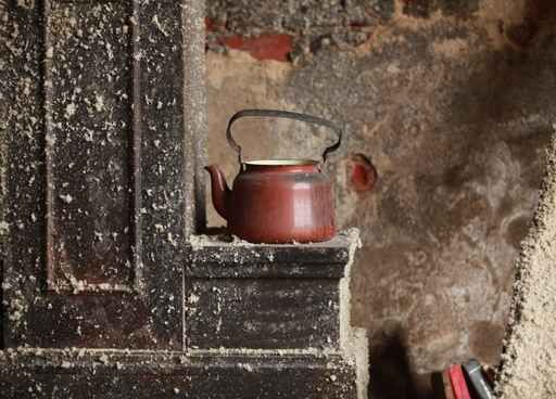 old kettle on the stove an abandoned house